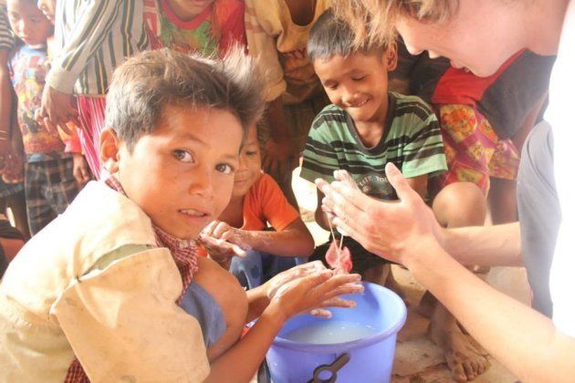 カンボジアで子供と手洗いをする荒井