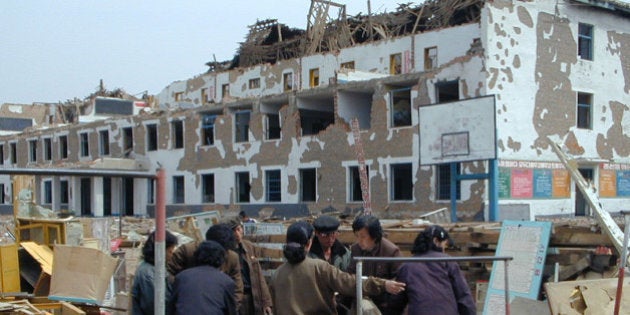 RYONGCHON, NORTH KOREA - UNDATED: In this handout photo released by the World Food Programme April 25, 2004 North Koreans attempt to clear rubble in Ryongchon, North Korea. Two trains collided April 22, 2004 at the train station in Ryongchon resulting in a huge explosion that destroyed thousands of buildings. The Red Cross have urgently requested more information on the disaster, which killed over 150 and injured some 1300, so they can help the victims of the tragedy. (Photo by World Food Programme via Getty Images)