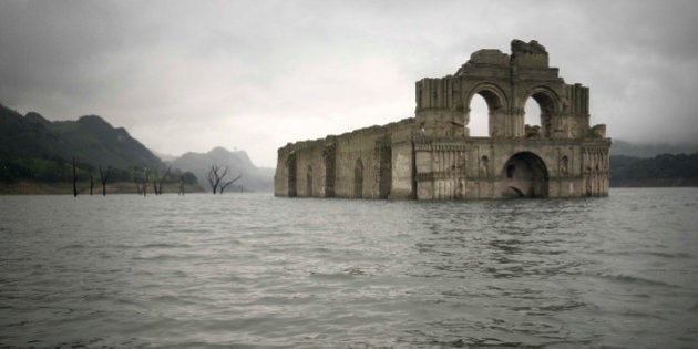 The remains of a mid-16th century church known as the Temple of Santiago, as well as the Temple of Quechula, is visible from the surface of the Grijalva River, which feeds the Nezahualcoyotl reservoir, due to the lack of rain near the town of Nueva Quechula, in Chiapas state, Mexico, Friday, Oct. 16, 2015. The temple, built by Dominican friars in the region inhabited by the Zoque people, was submerged in 1966 when the Nezahualcoyotl dam was built. (AP Photo/David von Blohn)