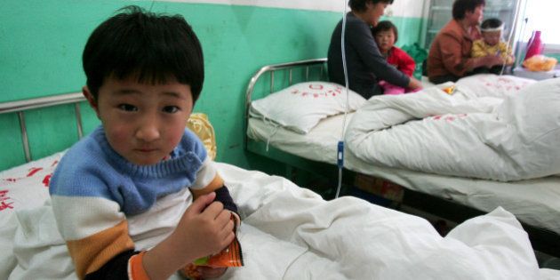 FUYANG, CHINA - APRIL 28: (CHINA OUT) A young girl who suffers from the hand, foot and mouth disease caused by the enterovirus 71, undergoes treatment in a hospital on April 28, 2008 in Fuyang of Anhui Province, east China. The lethal intestinal virus has struck 1,199 children and killed 20 of them in Fuyang. All of the victims were aged below six, of whom, the majority being children under the age of two. (Photo by China Photos/Getty Images)