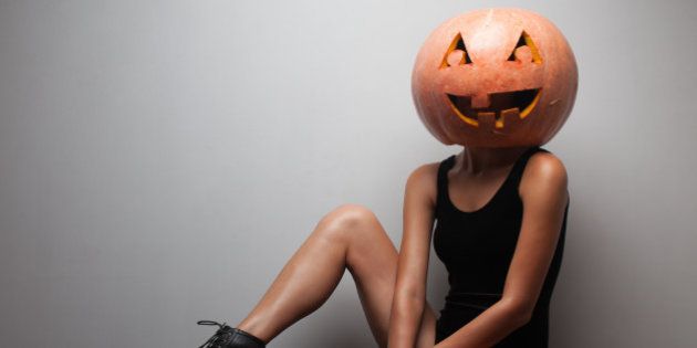 Fashionable Halloween model sitting.