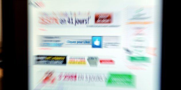 Picture taken at the AMF office in Paris on June 20, 2014 shows advertising Internet sites of Foreign exchange (Forex) type which are under watch by France's stock market regulator AMF due to their unbalanced sale propositions. AFP PHOTO ERIC PIERMONT (Photo credit should read ERIC PIERMONT/AFP/Getty Images)