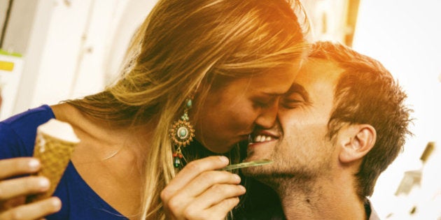 Young couple in love while eating an ice-cream.