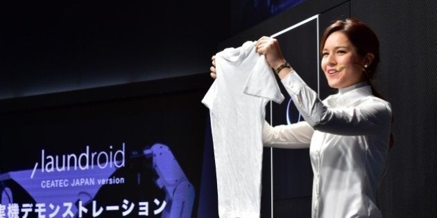 A model demonstrates a prototype of an automatic laundry folding machine during Ceatec, Asia's largest electronics trade show in Chiba, suburban Tokyo on October 7, 2015. Japan's Panasonic, Seven Dreamers and Daiwa House are expecting to commercialise automatic washing, folding, and clothes-sorting machines in 2017. AFP PHOTO / Yoshikazu TSUNO (Photo credit should read YOSHIKAZU TSUNO/AFP/Getty Images)