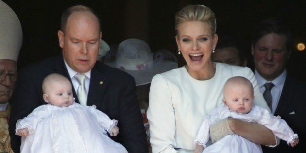 Prince Albert II of Monaco (L) and his wife Princess Charlene leave the cathedral after the baptism of their twins Prince Jacques and Princess Gabriella in Monte Carlo, on May 10, 2015. AFP PHOTO / VALERY HACHE (Photo credit should read VALERY HACHE/AFP/Getty Images)