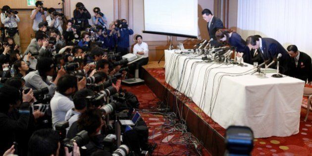 Haruko Obokata (R), 30, a female researcher of Japan's Riken Institute bows as she apologises at a press conference in Osaka, western Japan on April 9, 2014, following claims that her ground-breaking stem cell study was fabricated. Obokata is preparing to fight claims that her ground-breaking stem cell study was fabricated, her lawyer said on April 8, as Japan's male-dominated scientific establishment circled its wagons. AFP PHOTO / JIJI PRESS JAPAN OUT (Photo credit should read JIJI PRESS/AFP/Getty Images)