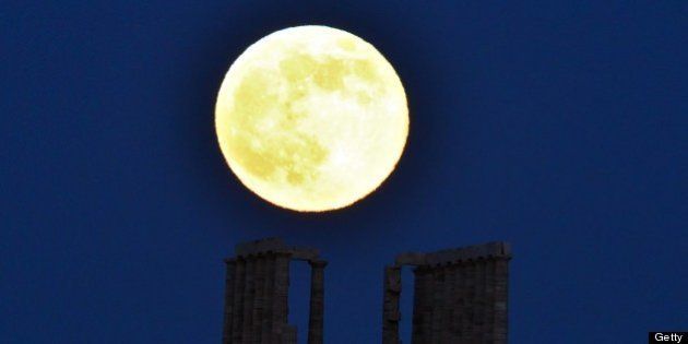 A supermoon rises next to the ancient Greek temple of Poseidon at Cape Sounion, some 65 kilometers south of Athens, on June 23, 2013. AFP PHOTO / ARIS MESSINIS (Photo credit should read ARIS MESSINIS/AFP/Getty Images)