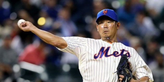 NEW YORK, NY - MAY 20: Daisuke Matsuzaka #16 of the New York Mets sends the ball to first in an attempt to pick off Yasiel Puig of the Los Angeles Dodgers at first base in the eighth inning on May 20, 2014 at Citi Field in the Flushing neighborhood of the Queens borough of New York City. (Photo by Elsa/Getty Images)