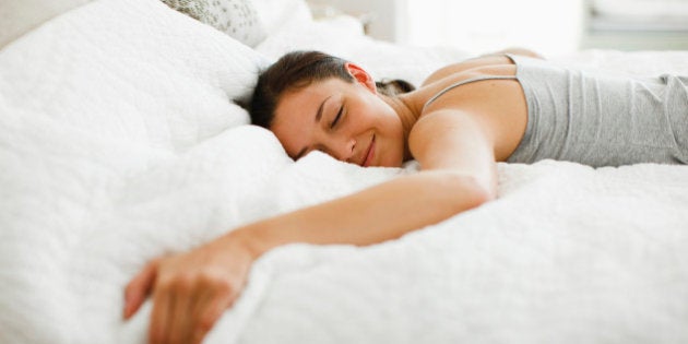 Happy woman laying on bed