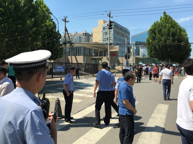 Police officers are seen standing guard near the U.S. embassy in Beijing, China July 26, 2018. REUTERS/Thomas Peter