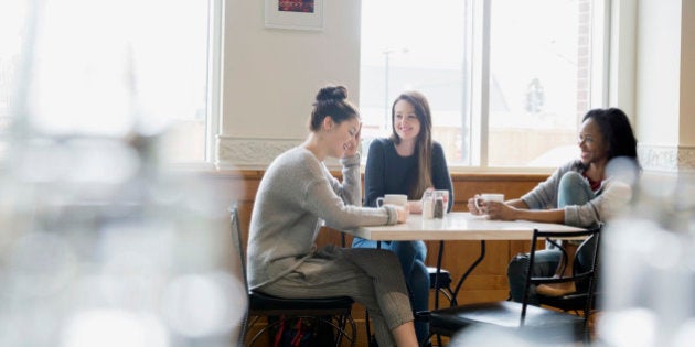 Friends enjoying coffee at cafe table