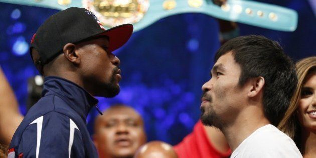 Floyd Mayweather Jr., left, and Manny Pacquiao pose during their weigh-in on Friday, May 1, 2015 in Las Vegas. The world weltherweight title fight between Mayweather Jr. and Pacquiao is scheduled for May 2. (AP Photo/John Locher)