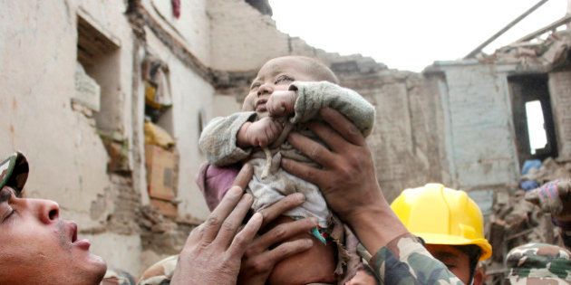 In this Sunday, April 26, 2015, photo taken by Amul Thapa and provided by KathmanduToday.com, four-month-old baby boy Sonit Awal is held up by Nepalese Army soldiers after being rescued from the rubble of his house in Bhaktapur, Nepal, after Saturday's 7.8-magnitude earthquake shook the densely populated Kathmandu valley. Thapa says that when he saw the baby alive after 20 hours of rescue efforts all my sorrow went. Everyone was clapping. It gave me energy and made me smile in spite of lots of pain hidden inside me.