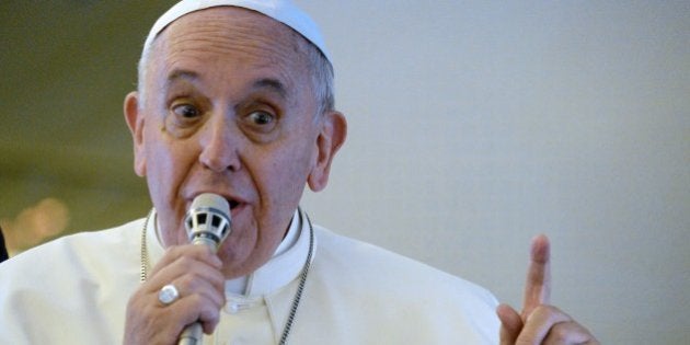 Pope Francis gives a press conference aboard the plane carrying him back to Rome at the end of a five-day trip to South-Korea, on August 18, 2014. AFP PHOTO / VINCENZO PINTO (Photo credit should read VINCENZO PINTO/AFP/Getty Images)