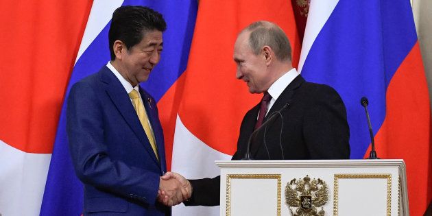 会談後の共同発表で握手する安倍晋三首相（左）とプーチン大統領＝1月22日、モスクワ