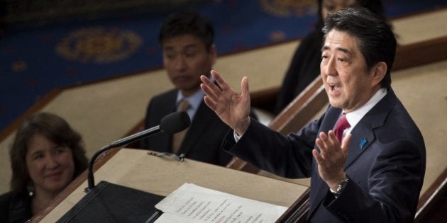 Japanese Prime Minister Shinzo Abe addresses a joint session of Congress at the US Capitol in Washington, DC, on April 29, 2015. AFP PHOTO/BRENDAN SMIALOWSKI (Photo credit should read BRENDAN SMIALOWSKI/AFP/Getty Images)