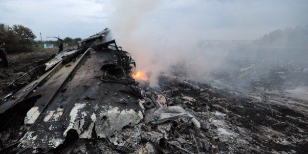A picture taken on July 17, 2014 shows wreckages of the malaysian airliner carrying 295 people from Amsterdam to Kuala Lumpur after it crashed, near the town of Shaktarsk, in rebel-held east Ukraine. Pro-Russian rebels fighting central Kiev authorities claimed on Thursday that the Malaysian airline that crashed in Ukraine had been shot down by a Ukrainian jet. AFP PHOTO/DOMINIQUE FAGET (Photo credit should read DOMINIQUE FAGET/AFP/Getty Images)