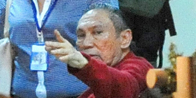 Former Panamenian dictator Manuel Noriega gestures upon arrival at the Renacer prison, 25 km south east of Panama City, on December 11, 2011. Panamanian former dictator, Manuel Noriega, 77, after more than two decades in prisons in the United States and France, returned home Sunday where he will continue to be incarcerated. AFP PHOTO/ Rodrigo ARANGUA (Photo credit should read RODRIGO ARANGUA/AFP/Getty Images)