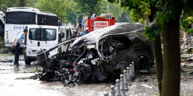 A destroyed van is pictured near a Turkish police bus which was targeted in a bomb attack in a central Istanbul district, Turkey, June 7, 2016. REUTERS/Osman Orsal
