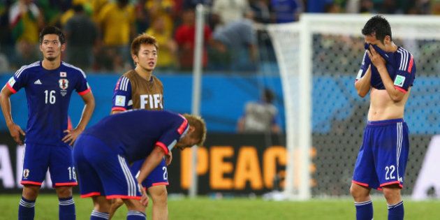 CUIABA, BRAZIL - JUNE 24: Maya Yoshida of Japan (R) reacts after the 2014 FIFA World Cup Brazil Group C match between Japan and Colombia at Arena Pantanal on June 24, 2014 in Cuiaba, Brazil. (Photo by Mark Kolbe/Getty Images)