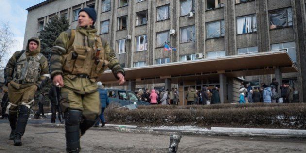 Local residents gather outside a building in the eastern Ukrainian city of Debaltseve on February 20, 2015. Germany and France demanded that a crumbling Ukraine truce be 'fully respected' even as pro-Russian rebels celebrated a battlefield victory in a strategic town and exchanged artillery fire elsewhere with government troops.AFP PHOTO/ ANDREY BORODULIN (Photo credit should read ANDREY BORODULIN/AFP/Getty Images)