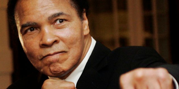 U.S. boxing great Muhammad Ali poses during the Crystal Award ceremony at the World Economic Forum (WEF) in Davos, Switzerland January 28, 2006. REUTERS/Andreas Meier/File Photo