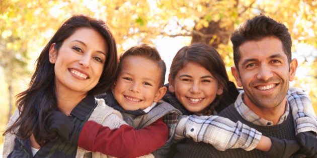 Portrait of happy parents piggybacking kids