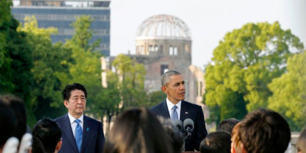 U.S. President Barack Obama gives a speech next to Japanese Prime Minister Shinzo Abe at Hiroshima Peace Memorial Park in Hiroshima, western, Japan, Friday, May 27, 2016. Obama on Friday became the first sitting U.S. president to visit the site of the world's first atomic bomb attack, bringing global attention both to survivors and to his unfulfilled vision of a world without nuclear weapons. The Atomic Bomb Dome is seen in the background. (Kimimasa Mayama/Pool Photo via AP)