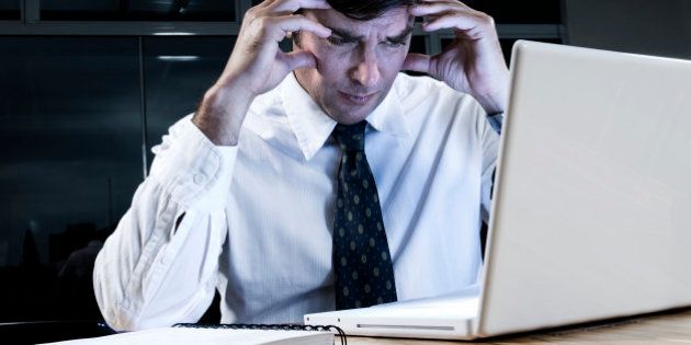 Stressed business man working on computer