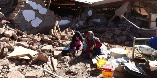 Pakistani earthquake survivors eat in their destroyed home in Charun Avir village, some 65 km north of Chitral on October 29, 2015. Rescuers say they believe they have reached most of those affected by the powerful earthquake that ripped across Pakistan this week, but thousands of desperate survivors now face a race to rebuild with winter fast approaching. AFP PHOTO / FAROOQ NAEEM (Photo credit should read FAROOQ NAEEM/AFP/Getty Images)