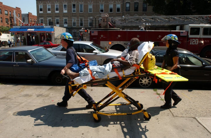 A woman suffering heat-related injuries is taken to the hospital in Brooklyn, New York, in July 2006.