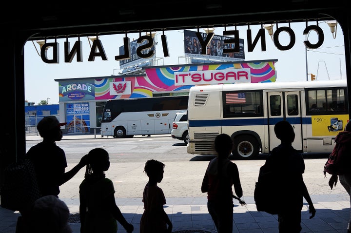 Children huddle in the shade near Coney Island, in Councilman Mark Treyger's district, during a brutal heatwave in 2013. 
