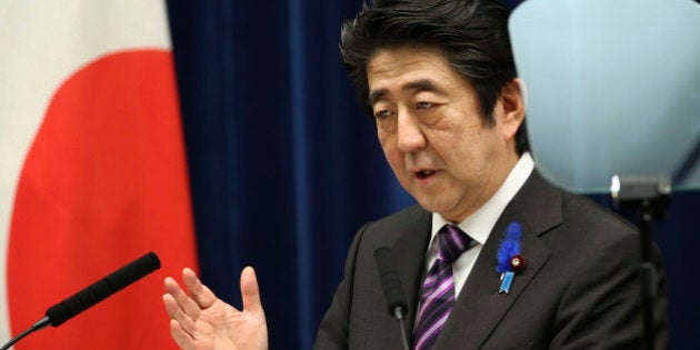 Japanese Prime Minister Shinzo Abe speaks during a press conference at his official residence in Tokyo Tuesday, July 1, 2014. Japan took a step away Tuesday from an American-drafted constitution that has long kept its military shackled, approving a plan to allow greater use of a force that was vanquished at the end of World War II. Abe said the shift is intended to protect the lives and security of the Japanese people. For example, he said, Japanese warships would be able to help protect U.S. ships that were fighting to defend Japan.