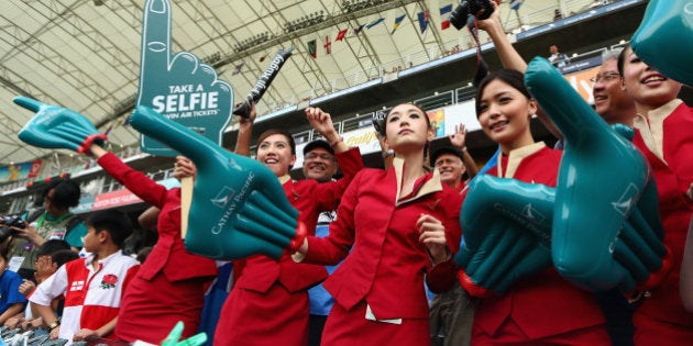 HONG KONG - MARCH 28: Cathay Pacific Air Crew dance during day one of the 2014 Hong Kong Sevens at Hong Kong International Stadium on March 28, 2014 in Hong Kong, Hong Kong. (Photo by Cameron Spencer/Getty Images)