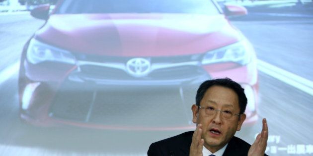 Akio Toyoda, president of Toyota Motor Corp., gestures as he speaks in front of a screen displaying an image of the company's Camry sedan during a news conference in Tokyo, Japan, on Thursday, May 8, 2014. Toyota, the world's largest carmaker, forecast profit will fall from last year's record as demand slumps in Japan, competition intensifies in the U.S. and the yen is no longer the boon it used to be. Photographer: Tomohiro Ohsumi/Bloomberg via Getty Images