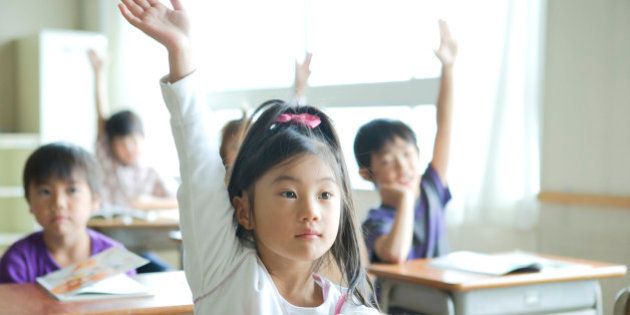 Schoolgirl (8-9) raising her hand