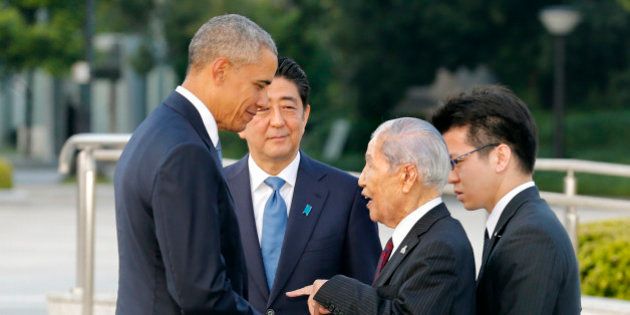 U.S. President Barack Obama, left, shakes hands and chats with Sunao Tsuboi, second right, a survivor of the 1945 atomic bombing and chairman of the Hiroshima Prefectural Confederation of A-bomb Sufferers Organization (HPCASO), as Japanese Prime Minister Shinzo Abe watches them during his visit to Hiroshima Peace Memorial Park in Hiroshima, western Japan, Friday, May 27, 2016. Obama on Friday became the first sitting U.S. president to visit the site of the world's first atomic bomb attack, bringing global attention both to survivors and to his unfulfilled vision of a world without nuclear weapons. (Kimimasa Mayama/Pool Photo via AP)