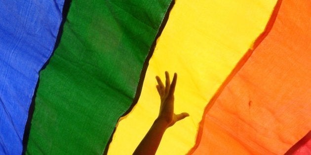 Members and supporters of the lesbian, gay, bisexual, transgender (LGBT) community walk with a rainbow flag during a rally in Kolkata on July 13, 2014. Hundreds of LGBT activists particpated in the rally to demand equal social and human rights for their community and stop social discrimination. AFP PHOTO/ Dibyangshu Sarkar (Photo credit should read DIBYANGSHU SARKAR/AFP/Getty Images)