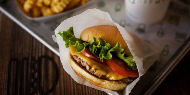 A burger, fries, and beverage are arranged for a photograph at a Shake Shack restaurant in New York, U.S., on Wednesday, Sept. 10, 2014. Shake Shack, the burger chain started by restauranteur Danny Meyer as a kiosk in a New York City park, is preparing for an initial public offering that could value it as high as $1 billion, people familiar with the matter said. Photographer: Michael Nagle/Bloomberg via Getty Images