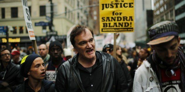 US film director Quentin Tarantino (C) takes part in a march against police brutality called 'Rise up October' on October 24, 2015, in New York. Campaigners demanding an end to police killings of unarmed suspects demonstrated and marched through Manhattan. AFP PHOTO/EDUARDO MUNOZ ALVAREZ (Photo credit should read EDUARDO MUNOZ ALVAREZ/AFP/Getty Images)