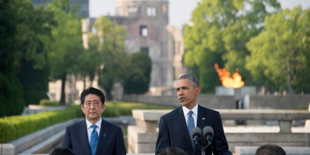 US President Barack Obama delivers remarks after laying a wreath at the Hiroshima Peace Memorial Park as Japan's Prime Minister Shinzo Abe (L) looks on, in Hiroshima on May 27, 2016.Obama on May 27 paid moving tribute to victims of the world's first nuclear attack. / AFP / JIM WATSON (Photo credit should read JIM WATSON/AFP/Getty Images)