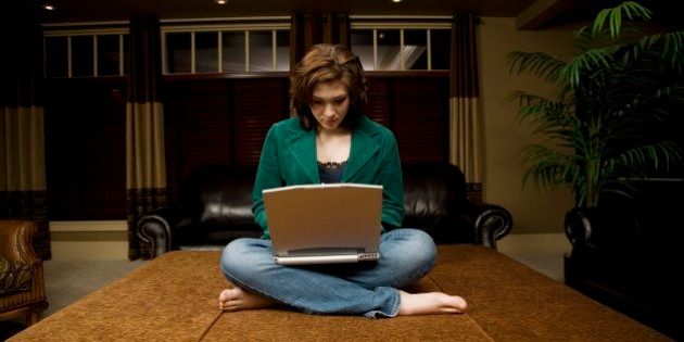 Woman working on laptop in living room