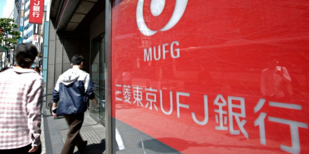 People enter a branch of Bank of Tokyo Mitsubishi UFJ Ltd. in Tokyo, Japan, on Wednesday, May 15, 2013. Japan's three biggest banks led by Sumitomo Mitsui Financial Group Inc. forecast earnings will decline this year as monetary easing makes loans less profitable even as borrowing picks up amid an economic recovery. Photographer: Kiyoshi Ota/Bloomberg via Getty Images