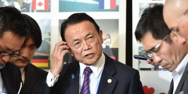 Japanese Finance Minister Taro Aso (C) speaks to reporters prior to a welcome reception hosted by the City of Sendai in Sendai on May 19, 2016. The group will converge at a hot spring town north of Tokyo where two days of meetings kick off from May 20. AFP PHOTO / KAZUHIRO NOGI / AFP / KAZUHIRO NOGI (Photo credit should read KAZUHIRO NOGI/AFP/Getty Images)