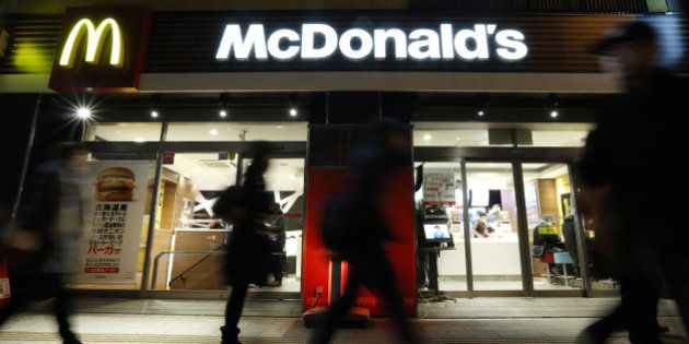 Pedestrians walk past a McDonald's restaurant, operated by McDonald's Holdings Co. Japan Ltd., at night in Tokyo, Japan, on Saturday, Feb. 6, 2016. McDonald's Japan is scheduled to announce its full-year earnings on Feb. 9. Photographer: Tomohiro Ohsumi/Bloomberg via Getty Images