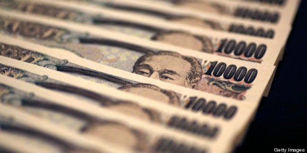 Japanese 10,000 yen banknotes are arranged for a photograph in Tokyo, Japan, on Monday, Feb. 25, 2013. The yen's protracted climb against the dollar over the past four decades is over, said Makoto Utsumi, a former top Japanese currency official. Photographer: Yuriko Nakao/Bloomberg via Getty Images