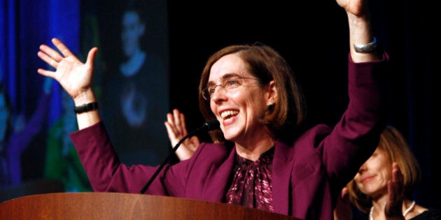 FILE - In this Nov. 6, 2012 file photo, Oregon Democratic Secretary of State Kate Brown celebrates at the podium after winning her race at Democratic headquarters in Portland, Ore. Brown has left a conference in Washington, D.C., and is making an unscheduled return to Oregon. Brown's abrupt return Wednesday, Feb. 11, 2015, comes as Gov. John Kitzhaber faces calls for his resignation. Brown would become governor if Kitzhaber leaves the office before the end of his term. (AP Photo/Don Ryan, File)