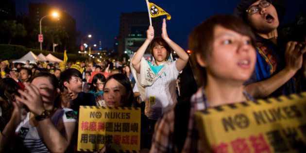 TAIPEI, TAIWAN - MARCH 09: Protesters hold signs during an anti-nuclear rally held on March 9, 2013 in Taipei, Taiwan. Tens of thousands of protesters took to the streets in Taiwan calling on the government to shut down the island's nuclear power plants, citing the painful lesson of Japan's nuclear crisis after 9.0-magnitude earthquake two years ago. (Photo by Lam Yik Fei/Getty Images)