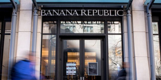 Pedestrians walk past a Banana Republic LLC store in Chicago, Illinois, U.S., on Friday, Feb. 19, 2016. The Gap Inc. is scheduled to release earnings figures on February 24. Photographer: Christopher Dilts/Bloomberg via Getty Images