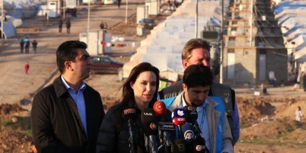 US actress and UNHCR ambassador Angelina Jolie delivers a speech during a visit to a camp for displaced Iraqis in Khanke, a few kilometres (miles) from the Turkish border in Iraq's Dohuk province, on January 25, 2015. Run by authorities from the three-province autonomous Kurdish region of north Iraq with the help of the United Nations refugee agency, the UNHCR, Khanke aims to house 18,000 people, said the agency's Liena Veide. AFP PHOTO/SAFIN HAMED (Photo credit should read SAFIN HAMED/AFP/Getty Images)